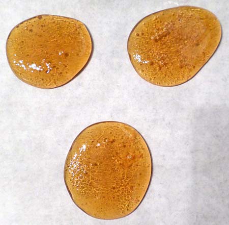 Three drops of maple syrup on baking paper