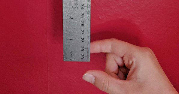 Hand ready to grab a ruler being dropped