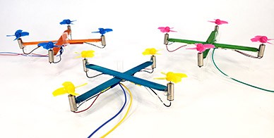 Three miniature drones made from popsicle sticks.  