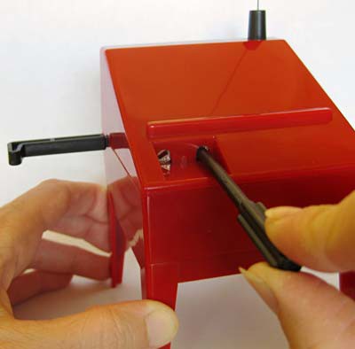 A tuning stick is placed in the right dial of a theremin