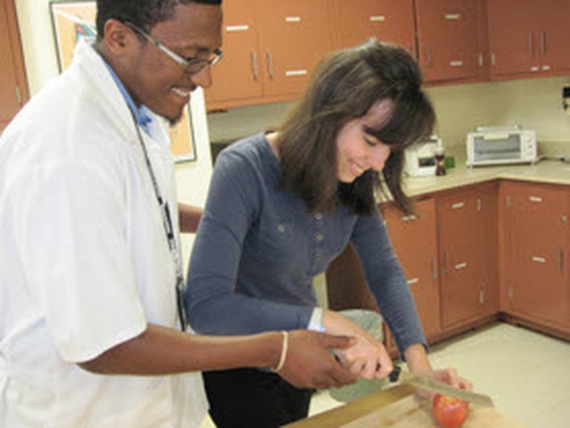 OT and patient cutting apple