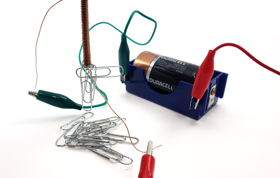 Electromagnet picking up paper clips