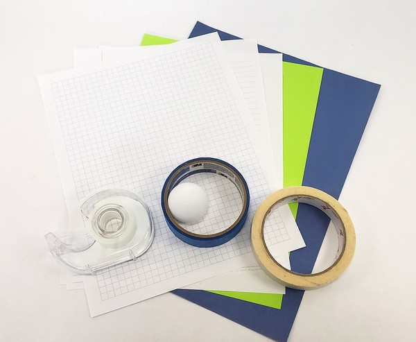 different types of paper, tape, and a ping pong ball for materials 