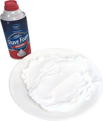 Spread a layer of shaving cream on the plate.