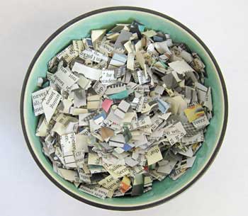 Thin strips of cut newspaper in a bowl