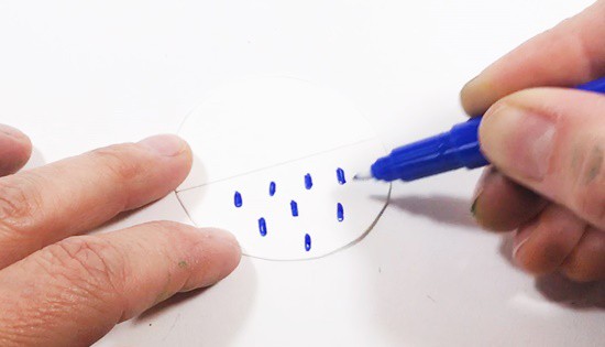 Blue raindrops are drawn into the bottom half of a paper circle.