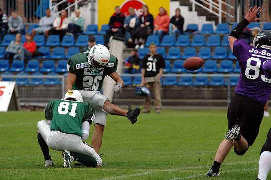 Photo of a football player kicking a football