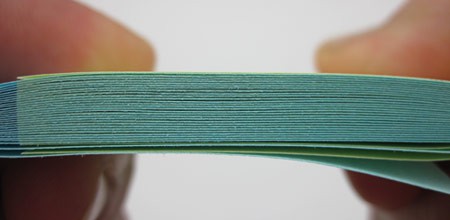 Close up image of a stack of interlaced paper from two paper pads