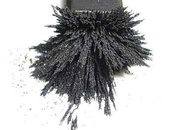Iron filings are pulled up towards a magnet