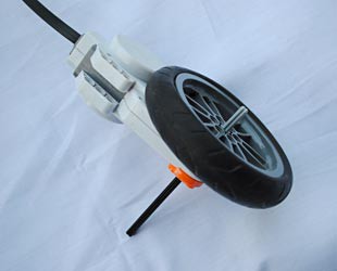 A LEGO wheel connects to a motor on an axle