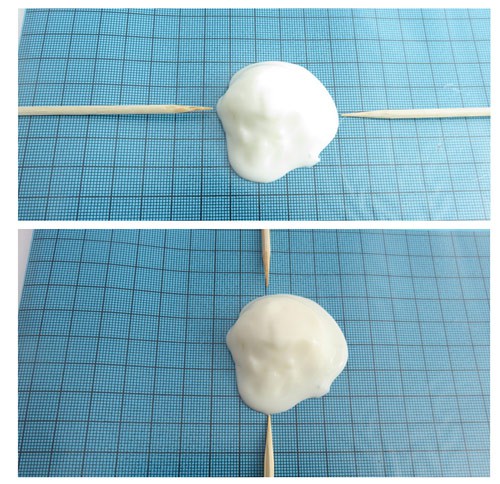Toothpicks are used to measure the widest and tallest points of a piece of ice cream placed on graph paper
