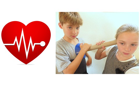 Heartbeat clipart next to a photo of a child using a cardboard tube and funnel to listen to the heartbeat of another child