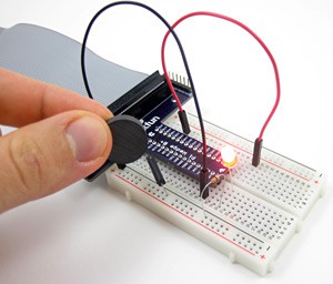 A magnet sensing circuit on a breadboard is turned on when a magnet is held near